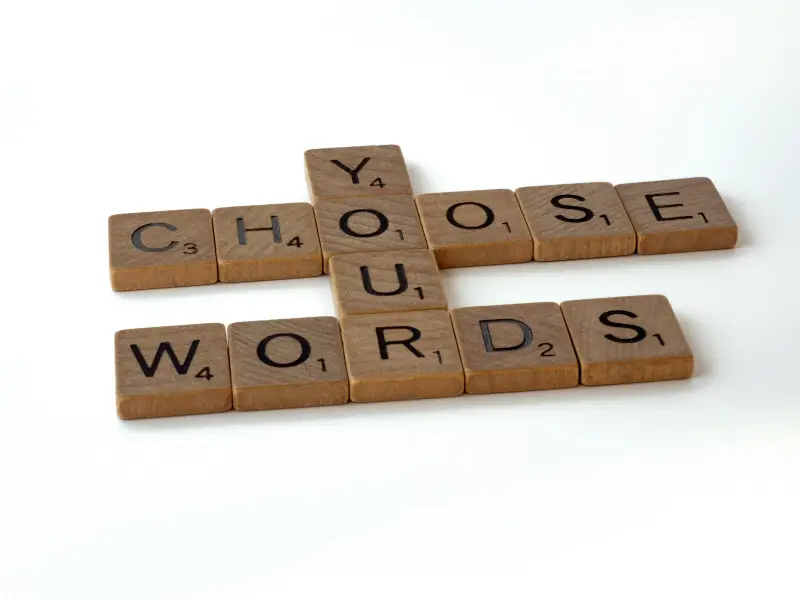 Choose your words spelled with wooden tiles, highlighting clarity in corporate communication
