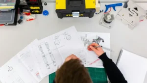 Professional designer working on detailed layout drawings, showcasing technical precision and visual planning skills.