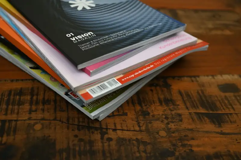 Stack of edited manuscripts and publications prepared for professional proofreading