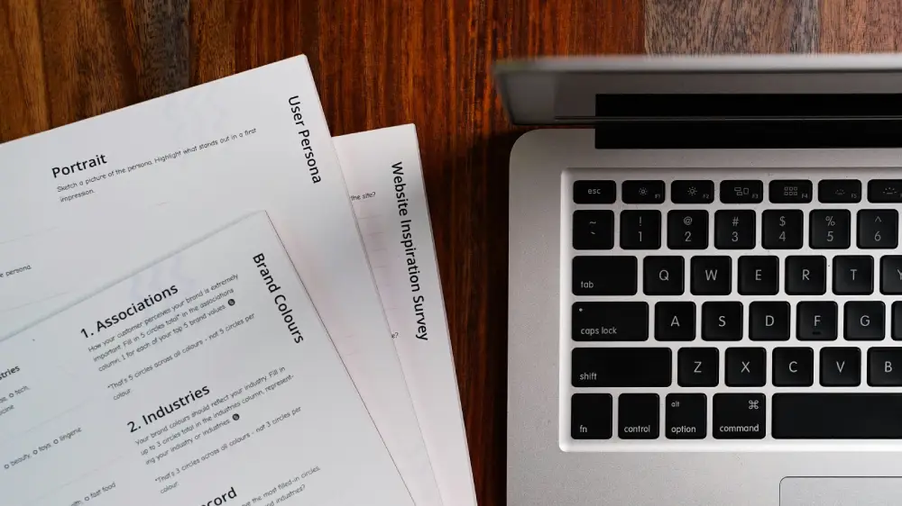 Business communication and annual reporting strategy materials displayed alongside a laptop workspace