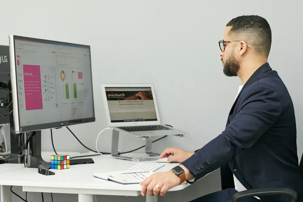 Financial analyst reviewing AI-generated market insights on multiple screens