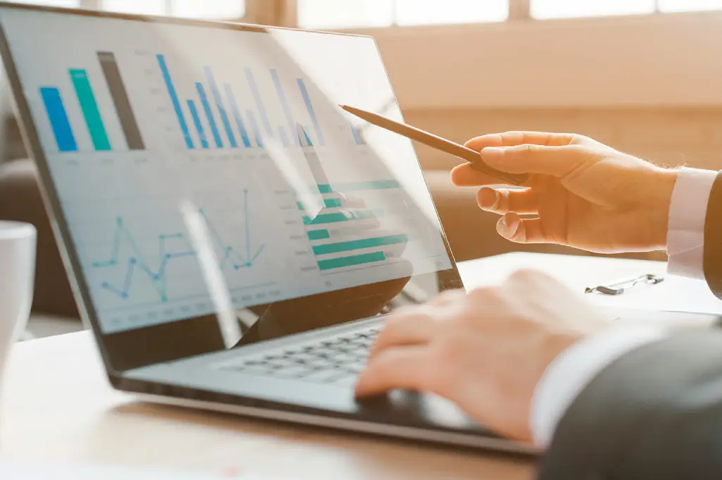 Business professional analyzing financial data charts for a FinTech content strategy
