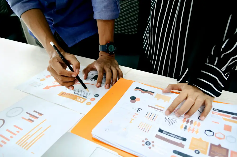 Team reviewing presentation charts and reports while planning an effective business presentation design strategy