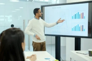 Professional presenting sales data using visually engaging business presentation design
