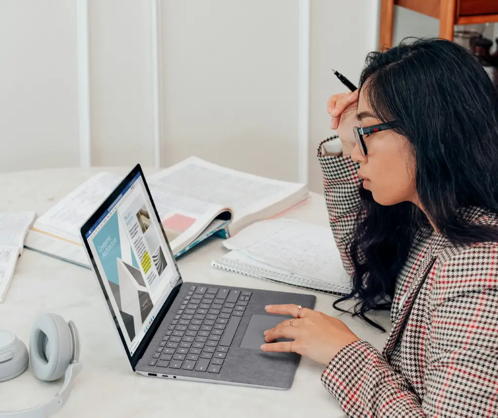 Stakeholders discussing business proposal design on a computer screen
