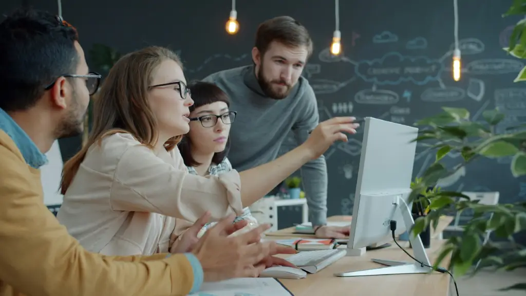 Woman studying a visually structured proposal design on a laptop